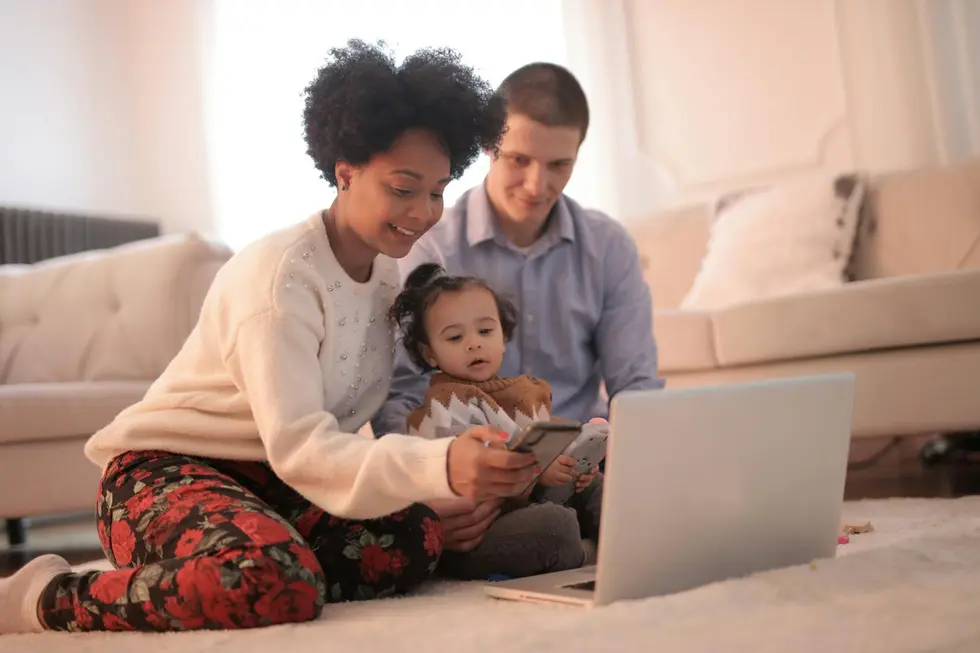 Família usando notebook e smartphone com dados de mercado em tempo real