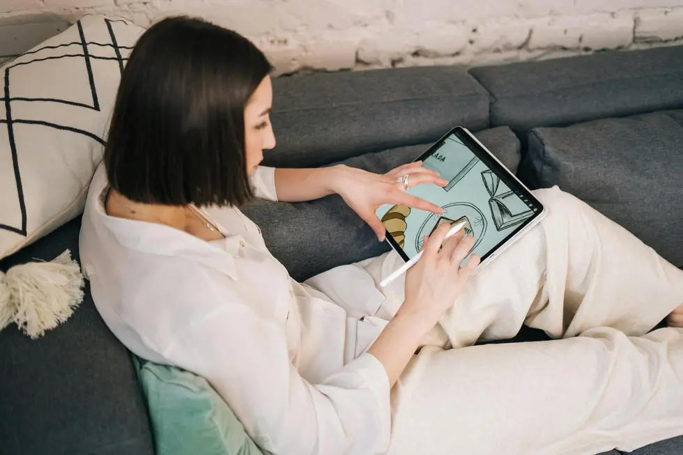 Família no sofá usando tablet com gráficos do Ripple XRP no gerenciamento financeiro