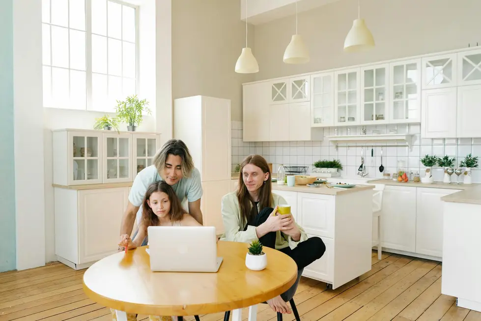 Família reunida usando laptop e smartphone com gráficos de market data