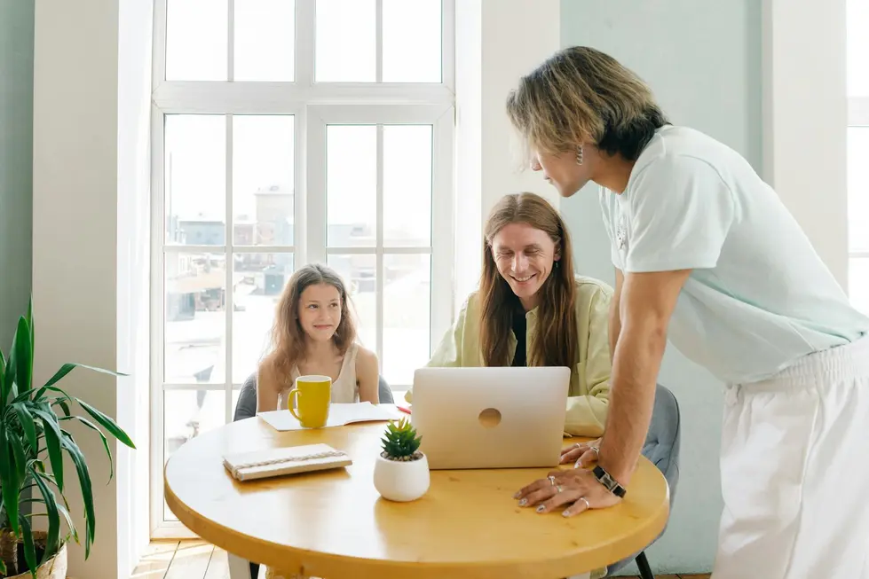 Família brasileira analisando gráficos de dados de mercado no notebook